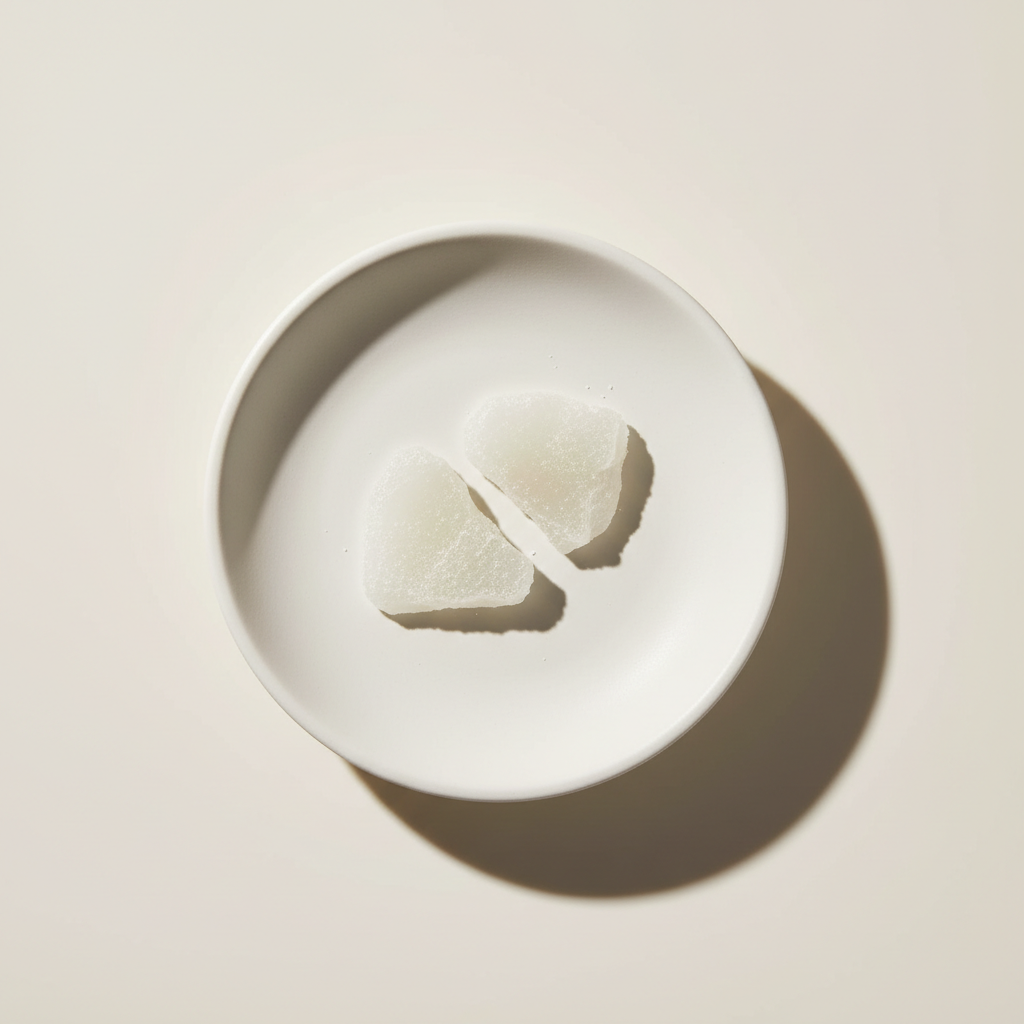 Shiny white flakes of Glycol Distearate, a key ingredient for pearlescent cosmetic products